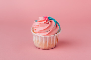 Yummy cupcake on light pink background close up