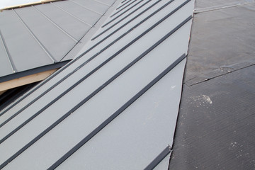 Obraz premium close up view of grey folding roof under construction on waterproofing layer
