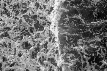 black-and-white view of the foaming waves