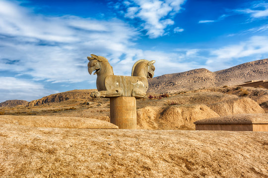 Persian Griffin, Persepolis. Iran is the capital of the Achaemenids. The ancient city of the Persians. Bright majestic monuments. Blue sky and clouds background.