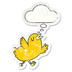 cartoon happy bird and thought bubble as a distressed worn sticker