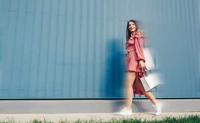 Shopping and tourism concept- beautiful girl with shopping bags in ctiy.