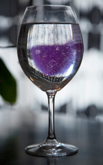 glass of water in interior with reflection