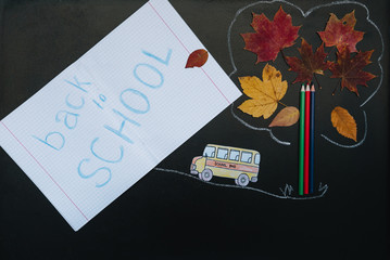 Back to school concept. School and office supplies on blackboard background.