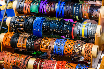 Different leather wristbands for sale on a street fair