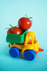 tomatoes natural vitamins are in the back of a truck in a children's toy car food delivery truck logistics