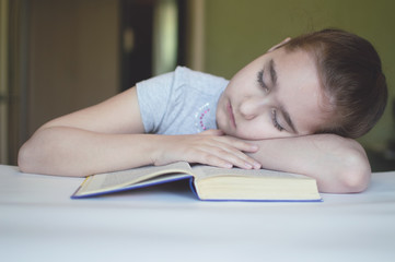 child reading a book at the table