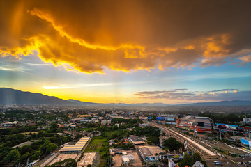 CHIANG MAI , THAILAND- JUNE 22, 2019 : Rain in the bright sky at the high angle of Chiang Mai cityscape and Doi Suthep as a background