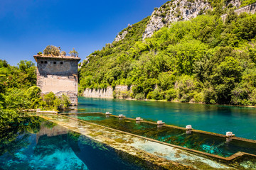 Fototapeta na wymiar The Roman port of ancient Narnia (Narni), in Stifone, in the canyons of the Nera river. The blue sky and the clear, cold and turquoise water, on a sunny day, in the summer. Wild and pristine nature.