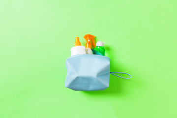 Top view of female cosmetics bag full of suncream spray, sunsreen, sunblock and body lotion and spf...
