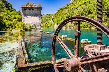 The Roman port of ancient Narnia (Narni), in Stifone, in the canyons of the Nera river. The blue sky and the clear, cold and turquoise water, on a sunny day, in the summer. Wild and pristine nature.