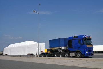 Oversize load or exceptional convoy (convoi exceptionnel). A truck with a special semi-trailer for...