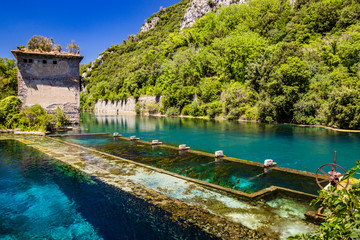 Fototapeta na wymiar The Roman port of ancient Narnia (Narni), in Stifone, in the canyons of the Nera river. The blue sky and the clear, cold and turquoise water, on a sunny day, in the summer. Wild and pristine nature.