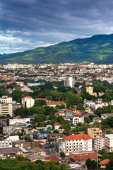 Fototapeta premium CHIANG MAI , THAILAND- JUNE 28, 2019 : Colorful hot-air balloons flying over Chiang Mai City with Doi Suthep Mountain background in Chiang Mai, Thailand.