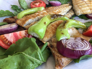 grilled sea bass served with vegetables and salad
