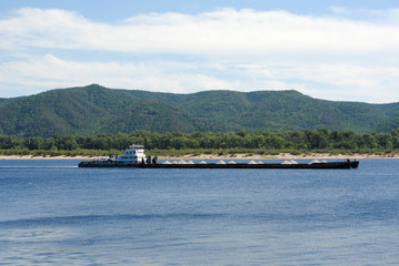 Fototapeta premium laden barge with rubble on the river
