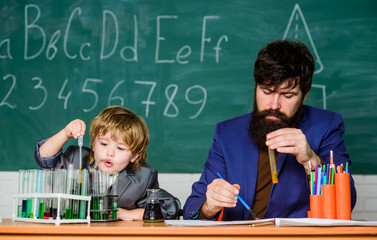 Pupil kid in the chemistry class confidence & charisma. Back to school. father and son at school. Science chemistry concept. bearded man teacher with little boy. Education is a birth right