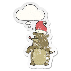 cartoon bear wearing christmas hat and thought bubble as a distressed worn sticker