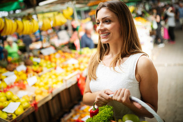 Picture of woman at marketplace buying vegetables