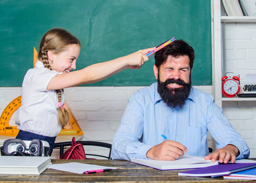 hate school. private lesson. back to school. Private teaching. small girl child with bearded teacher man in classroom. knowledge day. Home schooling. daughter study with father. Teachers day