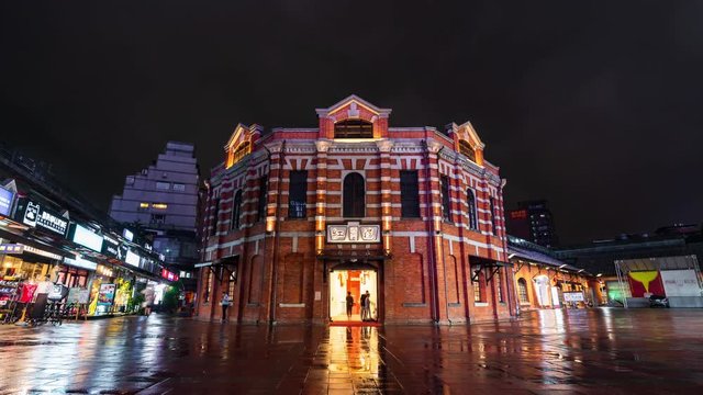 time lapse of The Red Chamber Theater or "The Red House Ximen" with falling rain in Ximending district at night in Taipei, Taiwan.