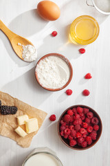 Food background top view. Mock up with ingredients for cooking pie or pancake on white background. Vertical. Summer berry. honey, blackberry, raspberry with copy space frame. Flat lay