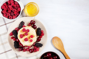 Top view Pancakes with honey syrup and berry for breakfast. Food for breakfast. Copy space for design. homemade american pancakes snack. Flat lay of sweet cherry, blackberry, raspberry and pancake