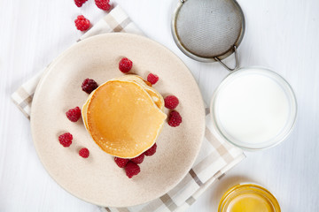 Top view Pancakes with honey or marple syrup and berry for breakfast. Food for breakfast. Copy space for design. homemade american pancakes snack. pancake with glass of milk