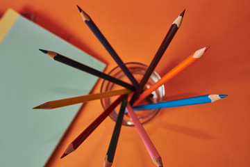  School supplies with notebooks and colored pencils.