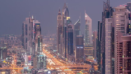 Aerial view to skyscrapers on Dubai downtown and Sheikh Zayed road day to night timelapse, Dubai, United Arab Emirates