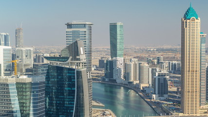 Aerial skyline of Dubai's business bay with skyscrapers timelapse before sunset.