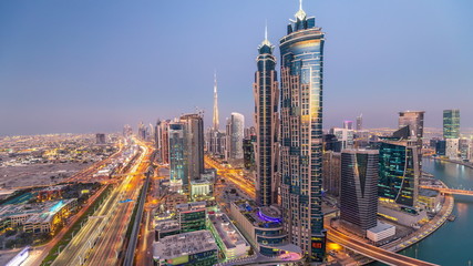 Obraz premium Evening skyline with modern skyscrapers and traffic on sheikh zayed road day to night timelapse in Dubai, UAE.