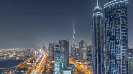 Fototapeta na wymiar Evening skyline with modern skyscrapers and traffic on sheikh zayed road night timelapse in Dubai, UAE.