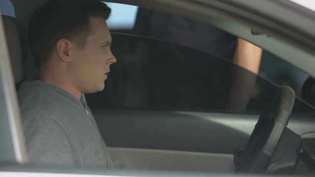 Policeman Knocking Car Window, Checking License Of Nervous Male Driver, Control