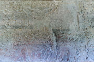 Famous bas reflief carved in the wall of Angkor Wat temple, world heritage and most visited tourist site, Cambodia. Details, close up of epic battles rock carving.