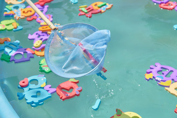 close up of floating colorful marine animal figures in the pool for catching a net. children's entertainment