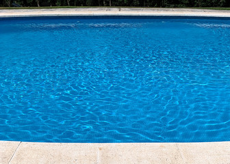 Fototapeta na wymiar clear blue water in the pool closeup