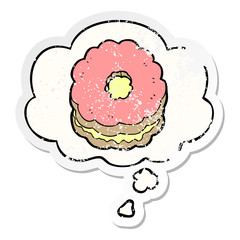 cartoon biscuit and thought bubble as a distressed worn sticker