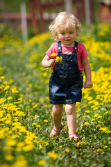 girl walking in a clearing among the flowers