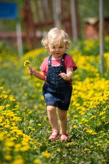 girl walking in a clearing among the flowers