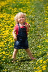 girl walking in a clearing among the flowers