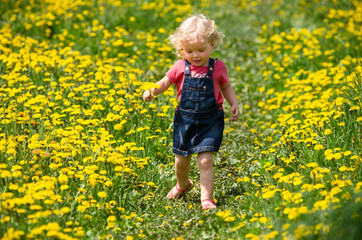 girl walking in a clearing among the flowers