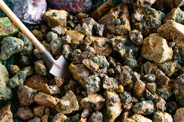 Mining. A miniature shovel and pieces of minerals with crystals.