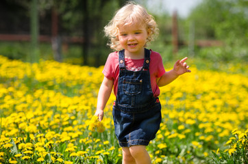 girl walking in a clearing among the flowers