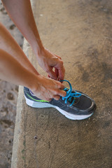 woman tying sneakers before training