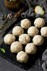 Homemade turkey meatballs raw on slate blackboard.