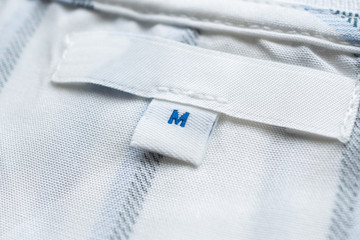 Blank white clothes label on new shirt