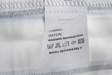 White laundry care washing instructions clothes label on rayon shirt