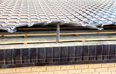 Installation of metal drain on the roof of the house