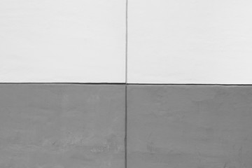 High resolution full frame background of a concrete wall painted in white and gray, 2x2 grid, in black and white.